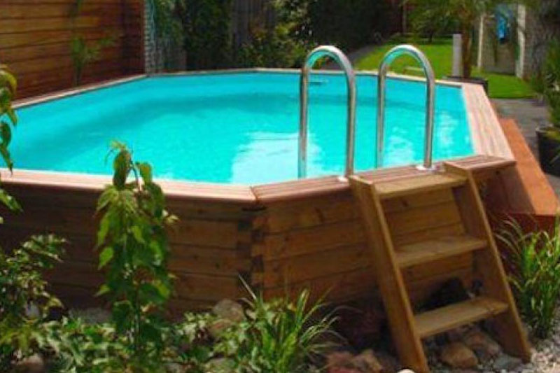 An above-ground pool with a simple wooden deck