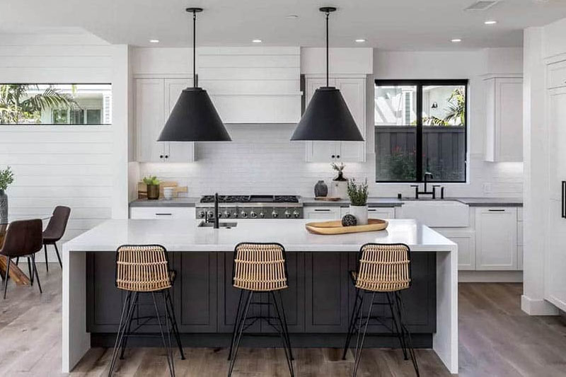 Minimalistic kitchen with white cabinets and black hardware