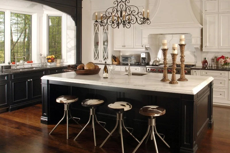 Wooden island and white cabinets with black hardware